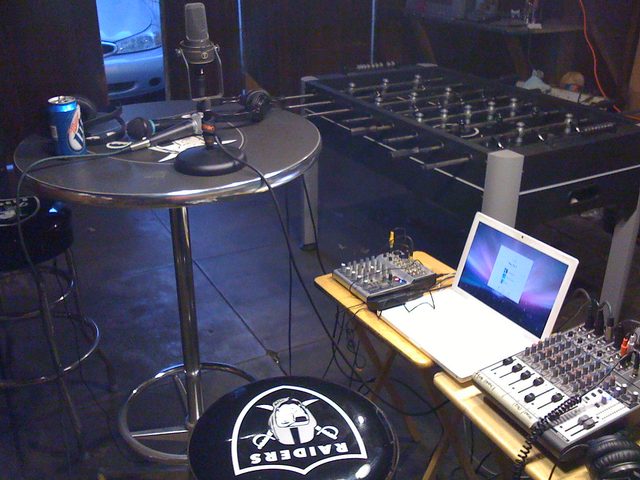 The Low Budget Barn: a bar table with microphones, mixers, a foosball table and a Raiders stool