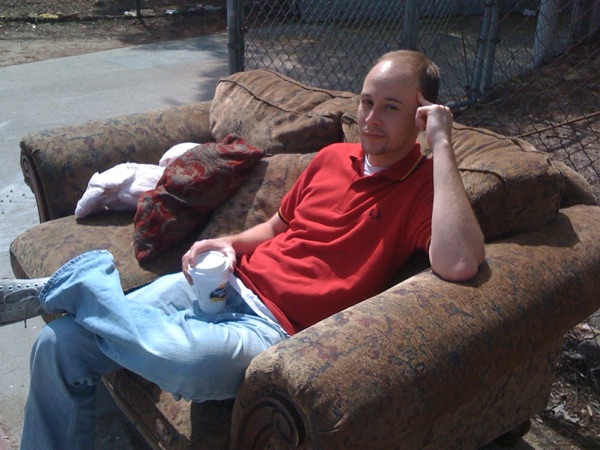 Tod Perry kicked back on a curbside couch with a coffee